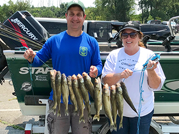 Two anglers show their catch after a successful walleye outing.