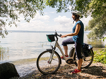  a woman on an e-bike resting near lake