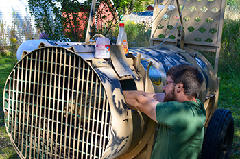 DNR wildlife technician Caleb Eckloff baits a bear trap in an attempt to relocate a problem bear.