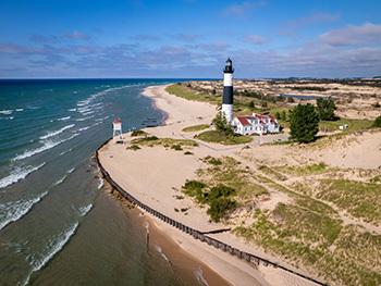 sandy lakeshore with lighthouse