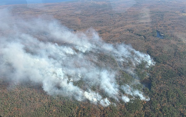 White smoke billows over the forest in the Ridge Fire, burning approximately 10 miles northwest of Marquette, Michigan