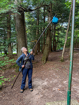A woman demonstrates how her bear bag is thrown.