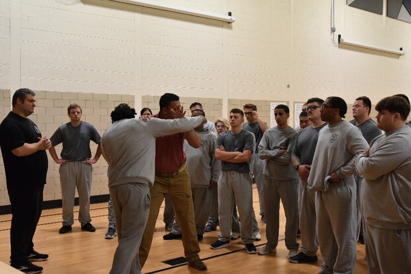 Recruits engaged in learning self-defense and prisoner management exercises