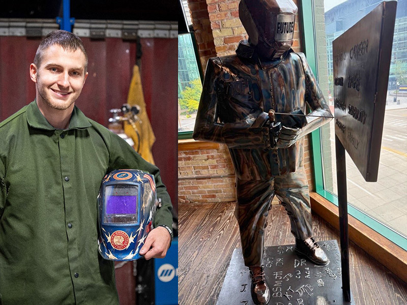 Man holding a welder's mask next to a welded sculpture of a man doing welding.