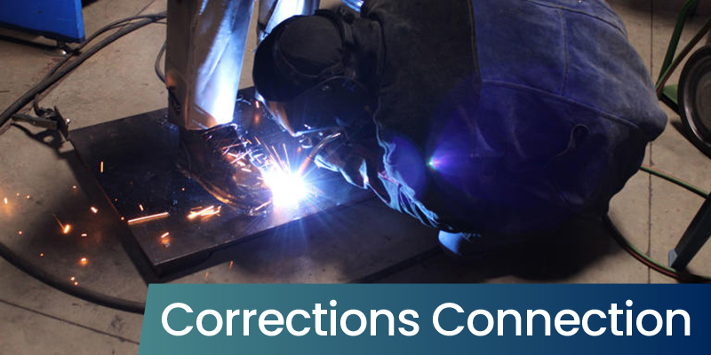 Man welding metal with a bright spark from the plasma cutter