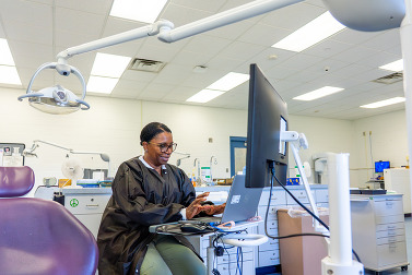 Dr. Maxwell at her chair.