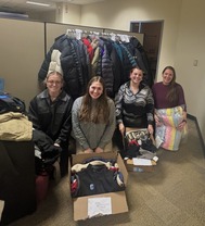 Madison and her team of interns sorting the donated winter gear.