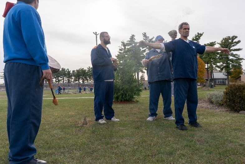 Prisoners engaged in a religious ceremony.