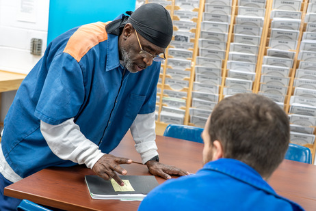 Men at Bellamy Creek Correctional Facility reviewing resources for release.