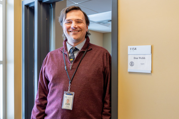 Dan Webb in front of his office. He is a white man with brown hair.