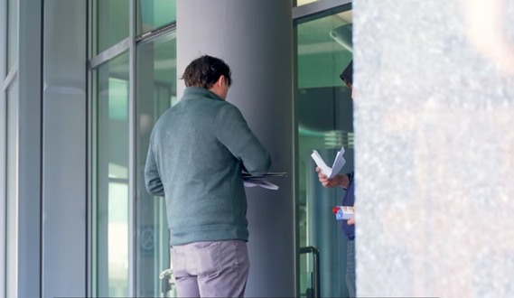 Agent Webb meeting with a man on probation at the library.