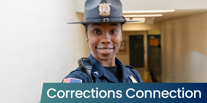 A woman with black hair smiles in a corrections uniform