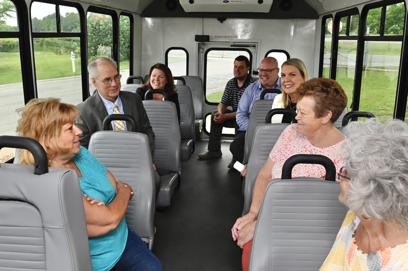 Transportation officials and transit supports ride a bus and discuss new technology initiatives.