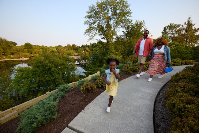 A girl and her parents walking at Frederik Meijer Gardens & Sculpture Park