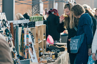 Two woman shopping at a stall at Eastern Market in Detroit.