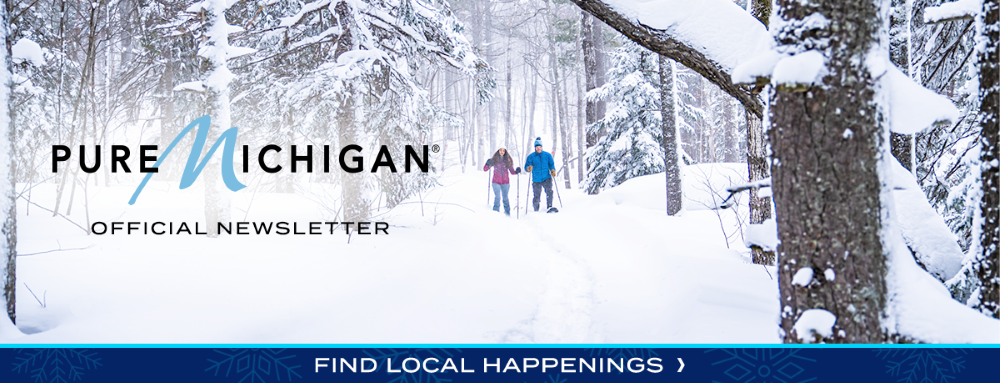 A graphic design showing two snowshoers in a forest with text reading "Pure Michigan Official Newsletter".