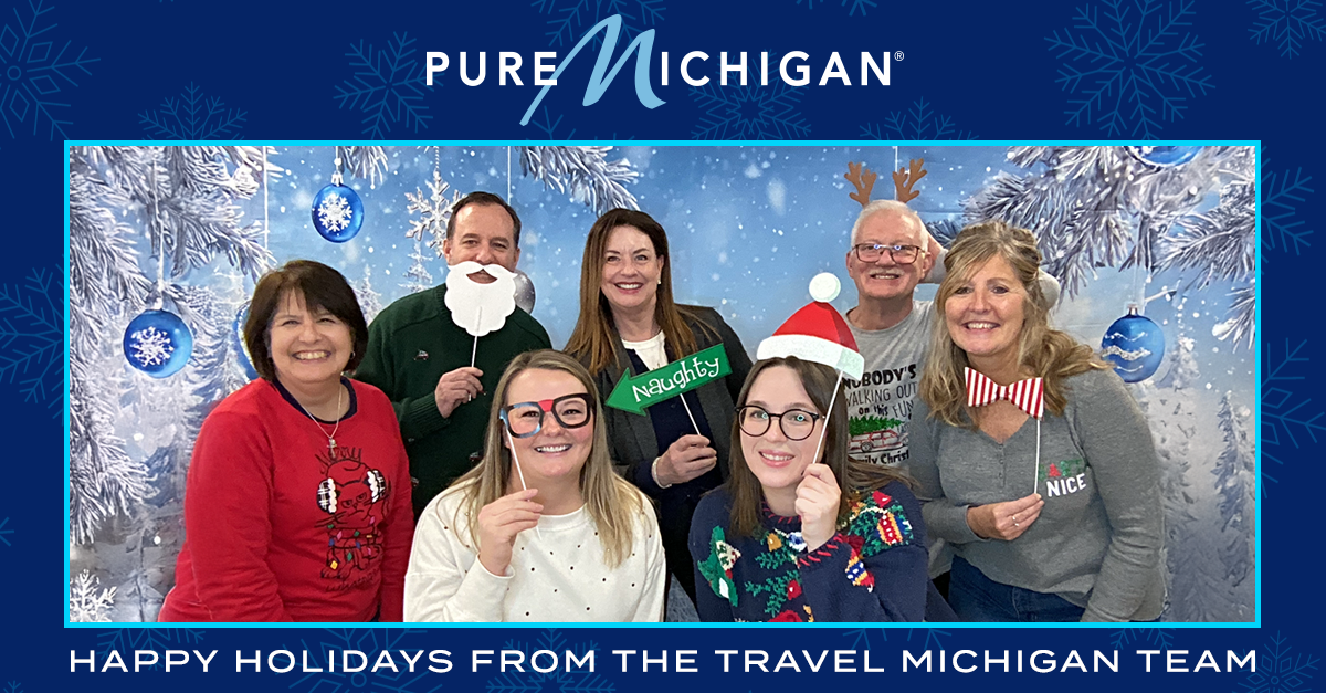 The Travel Michigan Team with a overlayed message that reads "Happy Holidays from the Travel Michigan Team".