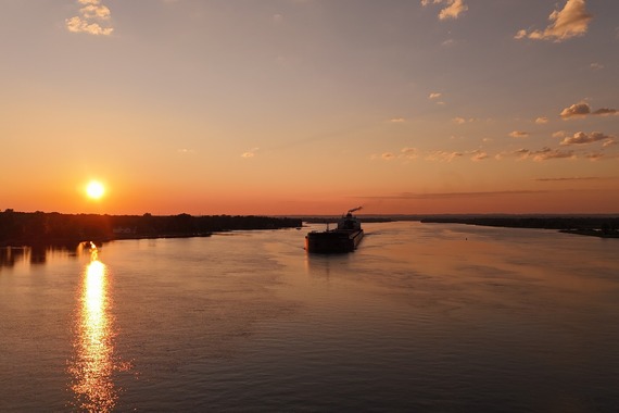 freighter ship on water at sunset 