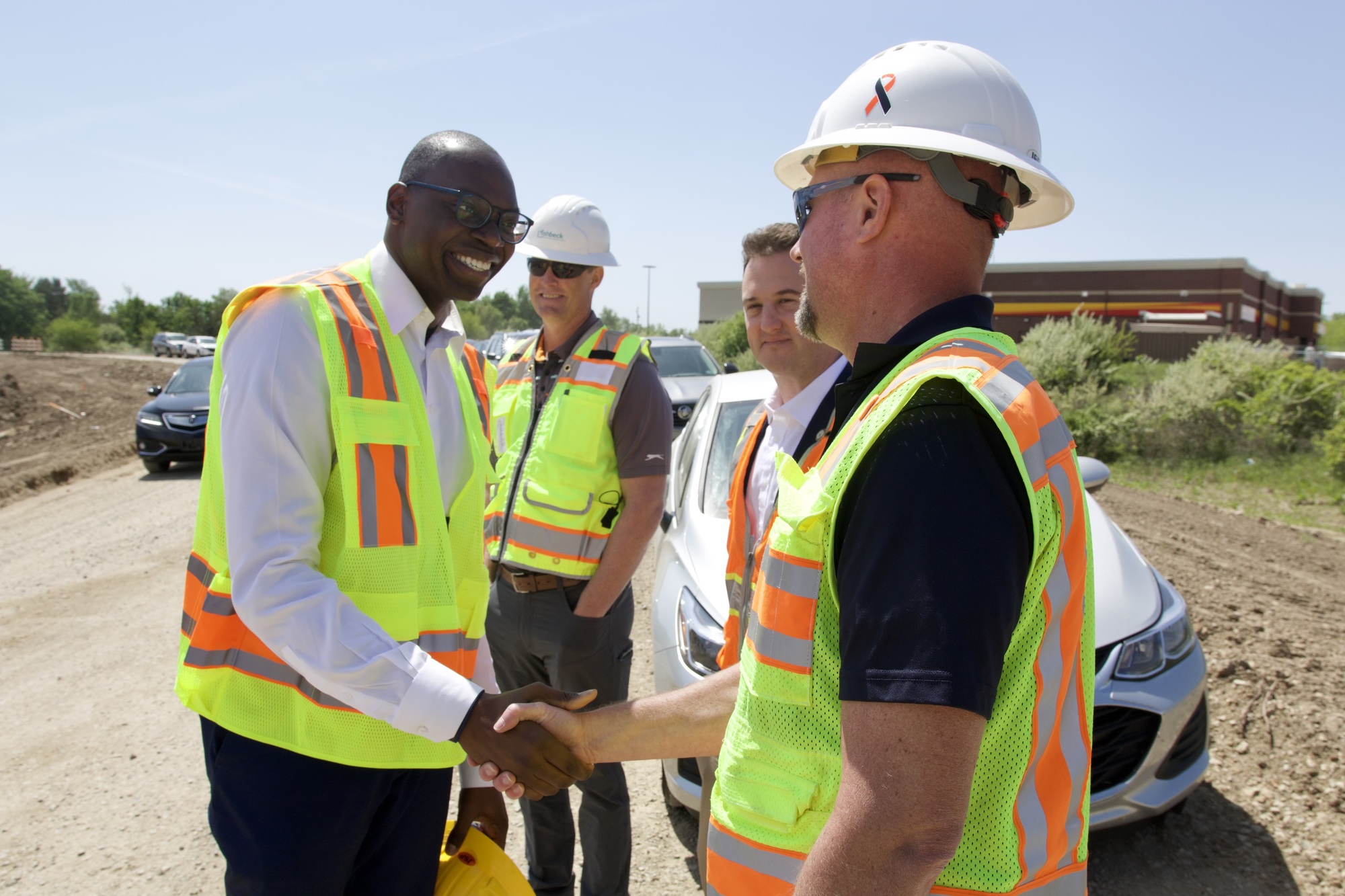 Lt. Gov shakes hands with an MDOT employee 