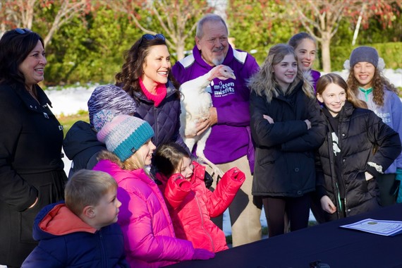 Governor Whitmer with group of kids and newly-pardoned turkey.