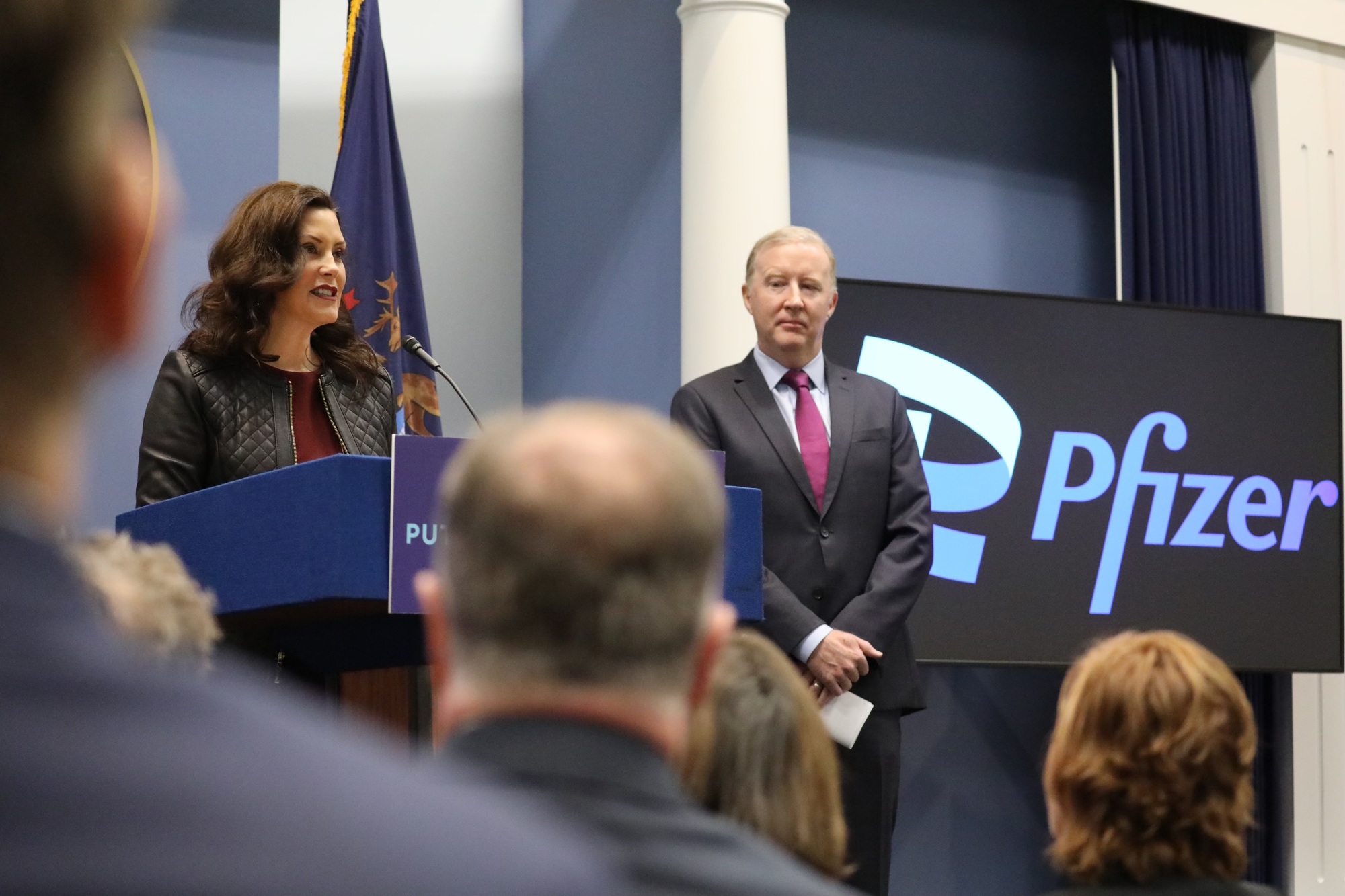 Gov. Whitmer speaks at podium during Pfizer announcement