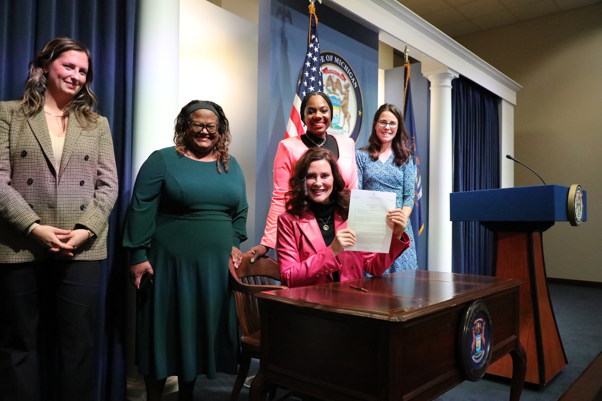 Gov. Whitmer holds up signed executive directive 