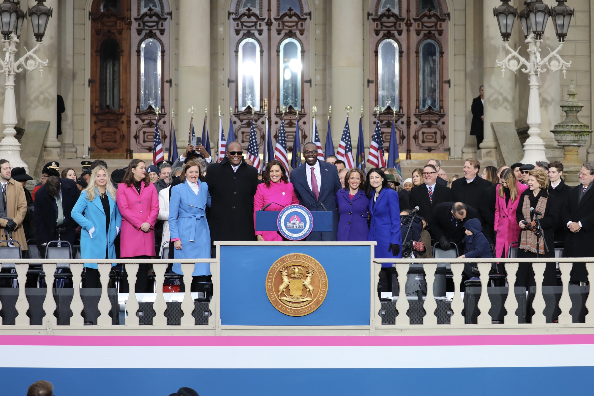 Governor Whitmer and her two daughters, Lieutenant Governor Gilchrist, Majority Leader Winnie Brinks, Speaker Joe Tate pose for a photo