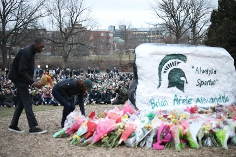Governor Whitmer and Lieutenant Governor Gilchrist lay flowers at the MSU vigil