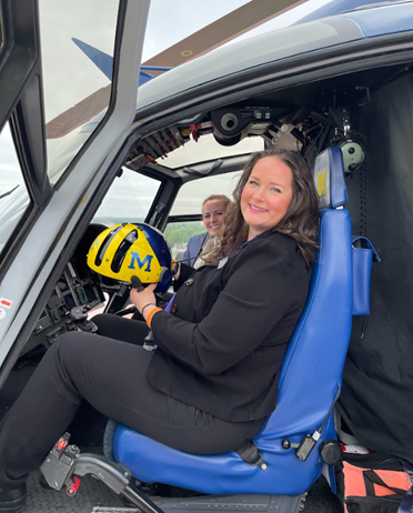 Representative Rheingans pictured sitting in a University of Michigan Health System helicopter