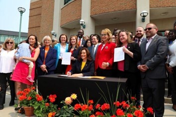 Rep. Erin Byrnes joined by her colleagues and Gov. Whitmer signing ERPO legislation into law.