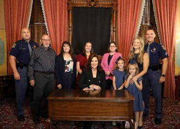 Rep. Hope standing with group and Gov. Whitmer at a recent bill signing.