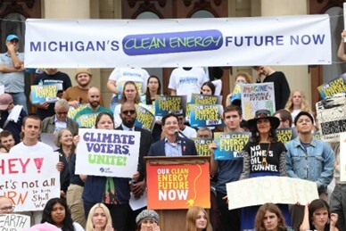 Rep. Morgan pictured speaking before large crown at the MLCV Climate Rally