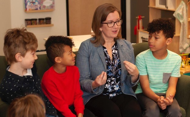 Rep. Natalie Price speaks to young children.
