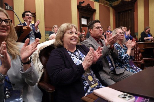 State Rep. Reggie Miller (D-Van Buren Township) applauds during the State of the State address at the Michigan Capitol on Wednesday, Jan. 24, 2024.
