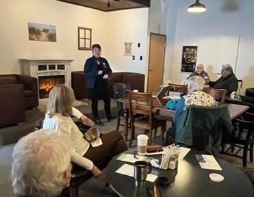 A photo of Rep. Coffia speaking to constituents at a coffee hour in Lake Ann
