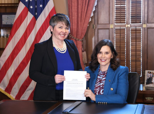 A photo of Rep. Coffia and Governor Whitmer at a bill signing ceremony