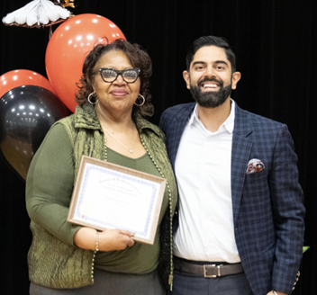 Rep. Puri stands with Teacher of the Month Ms. Brenda Johnson and her certificate of recognition.