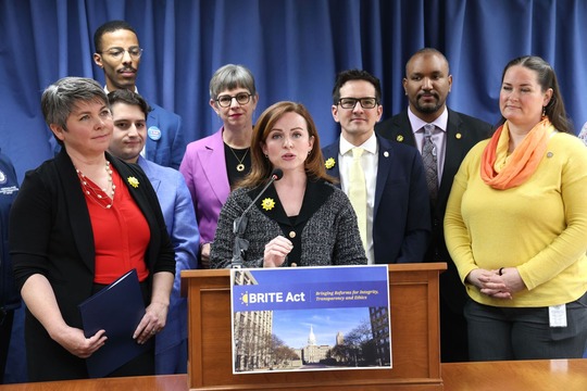 A photo of state Rep. Erin Byrnes speaking at the press conference while other representatives stand around her.