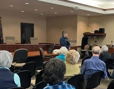 A photo of state Rep. Betsy Coffia speaking to attendees at a recent coffee hour.