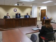 Commissioners participating in a Commission meeting