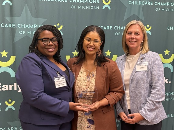 Founder and CEO of Little Dreamers Early Learning Center, Jacqueline Taylor, pose with her award and presenters