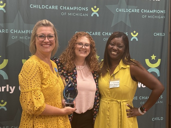 Winners pose for a photo with their award