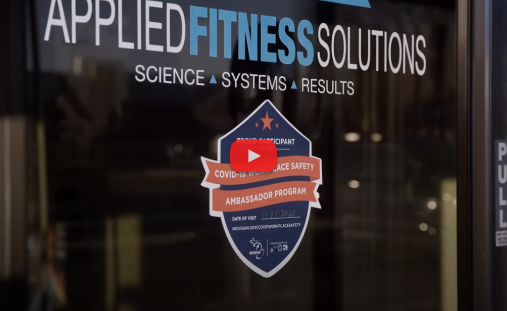 Picture of MIOSHA Ambassador window decal being added to a business storefront