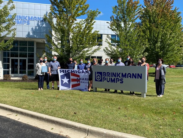 Company team posing with MSHARP flag