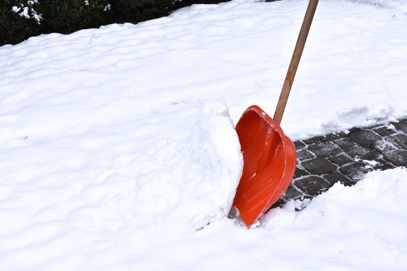Orange shovel in snow