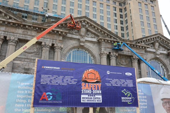 Safety stand--down sighn with Christman/Brinker, AGC and MIOSHA logos in front of Michigan Central Station 