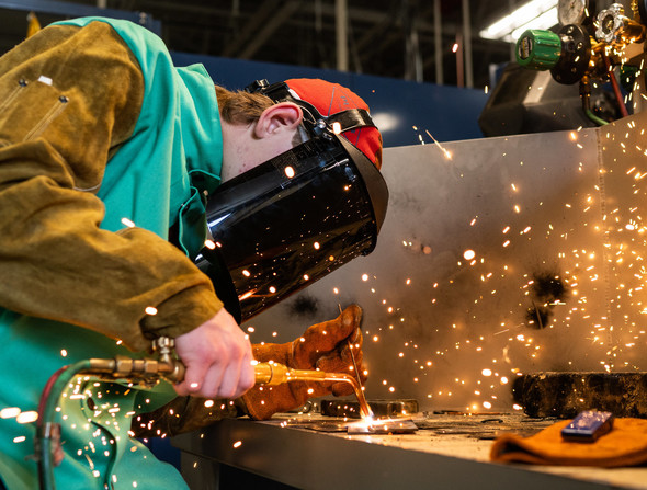 person welding in PPE