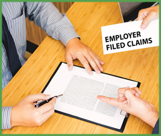 Photo of Employers at Desk FIling CLaim