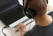 Person using braille keyboard