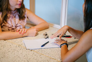 Close up of two people sitting across from one another at a table